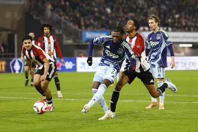 2025-12-17-19-26-07-rotterdam-l-r-jorthy-mokio-of-afc-ajax-scoort-de-0-4-daniel-lopes-varela-of-exce.webp