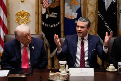 defense-secretary-pete-hegseth-speaks-as-president-donald-trump-looks-on-during-a-cabinet-meeting-at.webp