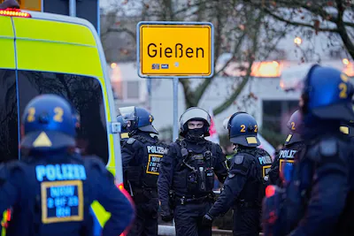 german-police-officers-stand-together-during-a-demonstration-against-the-planned-re-founding-of-the.webp