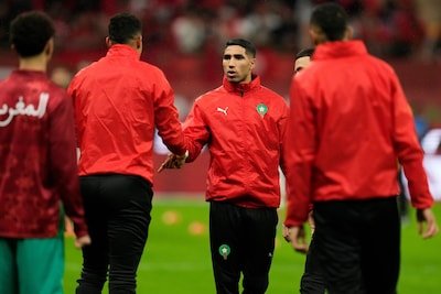 morocco-s-achraf-hakimi-shakes-hands-with-teammates-ahead-of-the-african-cup-of-nations-group-a-socc.jpeg