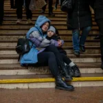 people-cover-in-a-metro-station-being-used-as-a-bomb-shelter-during-a-russian-drones-attack-in-kyiv.webp