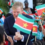 the-netherlands-king-willem-alexander-greets-people-among-surinamese-and-dutch-flags-during-an-offic.webp