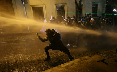 topshot-police-officers-use-water-cannons-to-desperse-demonstrators-during-clashes-as-part-of-a-prot.webp