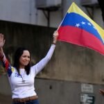 1768097644_files-venezuelan-opposition-leader-maria-corina-machado-waves-a-national-flag-during-a-protest-calle.jpeg