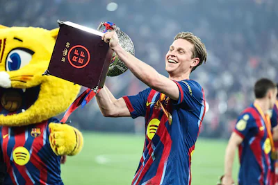 barcelona-s-dutch-midfielder-21-frenkie-de-jong-celebrates-with-the-trophy-after-winning-the-spanish.webp
