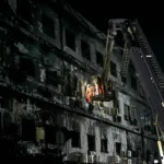 topshot-rescue-workers-search-for-bodies-among-the-rubble-after-a-massive-fire-broke-out-at-a-shoppi.webp