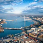 aerial-view-of-the-cityscape-and-lake-geneva-switzerland-during-a-sunny-winter-day-with-fog-clouds-a.webp