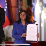 epa12760438-the-acting-president-of-venezuela-delcy-rodriguez-holds-the-document-of-the-approved-amn.webp