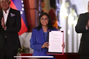 epa12760438-the-acting-president-of-venezuela-delcy-rodriguez-holds-the-document-of-the-approved-amn.webp