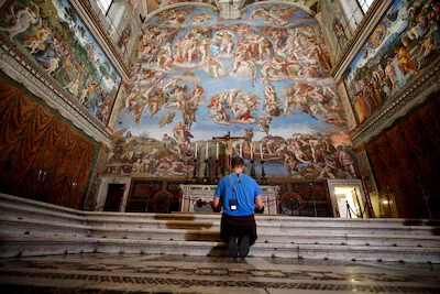 file-a-visitor-kneels-in-front-of-the-last-judgement-fresco-by-the-italian-renaissance-painter-miche.webp