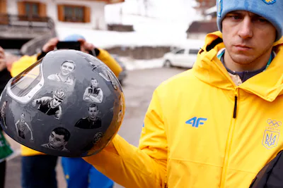 ukraine-s-skeleton-racer-vladyslav-heraskevych-holds-his-helmet-which-depicts-victims-of-his-country.webp