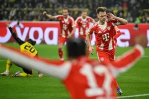 bayern-munich-s-german-midfielder-06-joshua-kimmich-celebrates-scoring-the-2-3-goal-with-his-teammat.webp