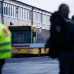 epa12780729-employees-stand-in-front-of-a-resting-bus-at-the-bvg-bus-depot-lichtenberg-during-a-publ.webp