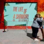 file-photo-people-hug-outside-a-spotify-pop-up-event-for-taylor-swift-s-album-the-life-of-a-showgirl.webp