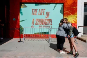 file-photo-people-hug-outside-a-spotify-pop-up-event-for-taylor-swift-s-album-the-life-of-a-showgirl.webp
