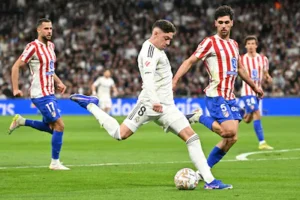 real-madrid-s-uruguayan-midfielder-08-federico-valverde-is-challenged-by-atletico-madrid-s-us-midfie.webp