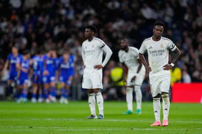 real-madrid-s-vinicius-junior-reacts-as-getafe-s-satriano-celebrates-with-team-mates-the-opening-goa.webp