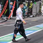 red-bull-racing-s-french-driver-isack-hadjar-walks-in-the-pits-during-the-formula-one-australian-gra.webp