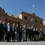 accredited-journalists-pose-for-pictures-in-front-of-casa-rosada-government-palace-after-argentina-s.webp
