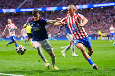 arsenal-s-piero-hincapie-left-and-atletico-madrid-s-marcos-llorente-battle-for-the-ball-during-a-cha.webp