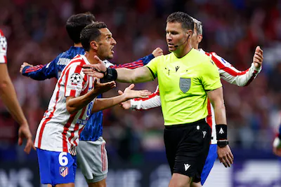 madrid-spain-april-29-referee-danny-makkelie-argues-with-koke-of-atletico-madrid-during-the-uefa-cha.webp