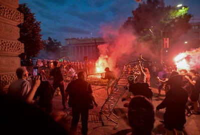 a-group-of-demonstrators-clash-with-riot-police-outside-serbia-s-parliament-building-at-the-end-of-a.webp