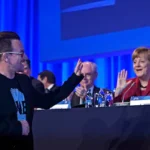epa04113834-german-chancellor-angela-merkel-r-greets-u2-singer-bono-l-as-he-arrives-to-deliver-a-spe.webp