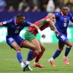 atlanta-georgia-june-24-sofyan-amrabat-4-of-morocco-is-challenged-by-wilson-isidor-18-of-haiti-durin.webp