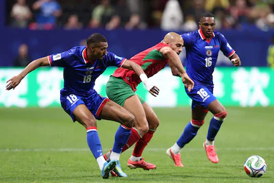 atlanta-georgia-june-24-sofyan-amrabat-4-of-morocco-is-challenged-by-wilson-isidor-18-of-haiti-durin.webp
