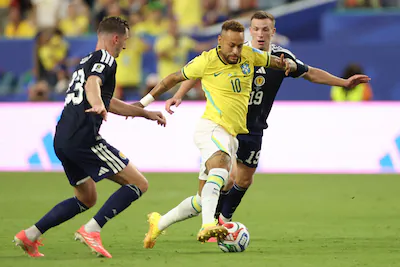 brazil-s-forward-10-neymar-scotland-s-midfielders-23-kenny-mclean-and-19-lewis-ferguson-fight-for-th.webp