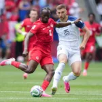 canada-s-ismael-kone-8-passes-the-ball-while-being-chased-by-bosnia-s-jovo-lukic-25-during-the-first.webp