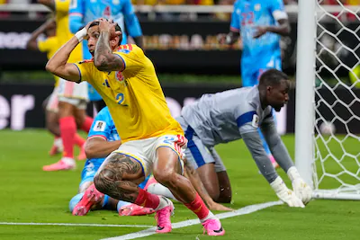 colombia-s-daniel-munoz-2-reacts-after-a-missed-shot-at-goal-during-the-world-cup-group-k-soccer-mat.webp