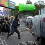 demonstrators-clash-with-police-officers-during-a-protest-on-the-day-of-the-opening-match-of-the-202.webp