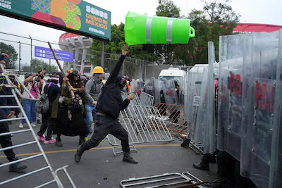 demonstrators-clash-with-police-officers-during-a-protest-on-the-day-of-the-opening-match-of-the-202.webp