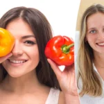 handsome-young-woman-is-holding-salad-peppers-in-front-of-her-eyes-while-standing-against-white-back.webp
