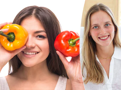 handsome-young-woman-is-holding-salad-peppers-in-front-of-her-eyes-while-standing-against-white-back.webp