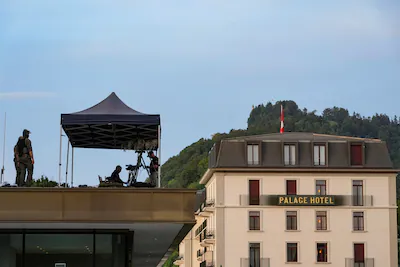 u-s-secret-service-counter-snipers-stand-guard-on-a-roof-at-buergenstock-resort-lake-lucerne-on-the.webp