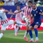 1783203064_paraguay-s-juan-jose-caceres-4-his-teammate-diego-gomez-and-france-s-adrien-rabiot-vie-for-the-ball.jpeg
