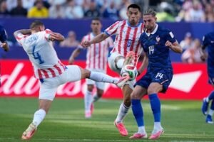 1783203064_paraguay-s-juan-jose-caceres-4-his-teammate-diego-gomez-and-france-s-adrien-rabiot-vie-for-the-ball.jpeg