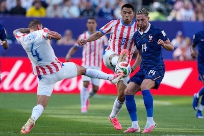 1783203064_paraguay-s-juan-jose-caceres-4-his-teammate-diego-gomez-and-france-s-adrien-rabiot-vie-for-the-ball.jpeg