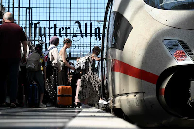 passengers-board-an-ice-intercity-express-train-of-german-rail-operator-deutsche-bahn-at-frankfurt-c.webp