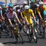 slovenia-s-tadej-pogacar-center-wearing-the-overall-leader-s-yellow-jersey-rides-in-the-pack-during.webp