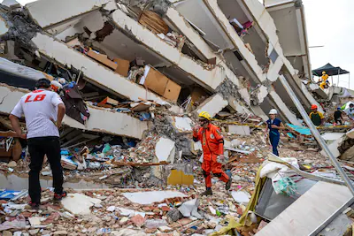 volunteers-and-a-mexican-rescuer-help-to-find-survivors-in-a-collapsed-building-in-caraballeda-la-gu.webp